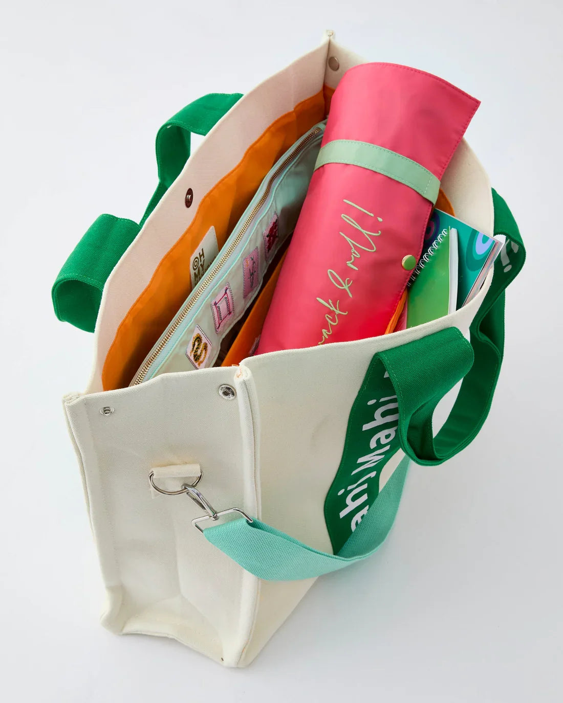 Green Mahj It All bag open with a rolled rack bag inside; accessories sold separately