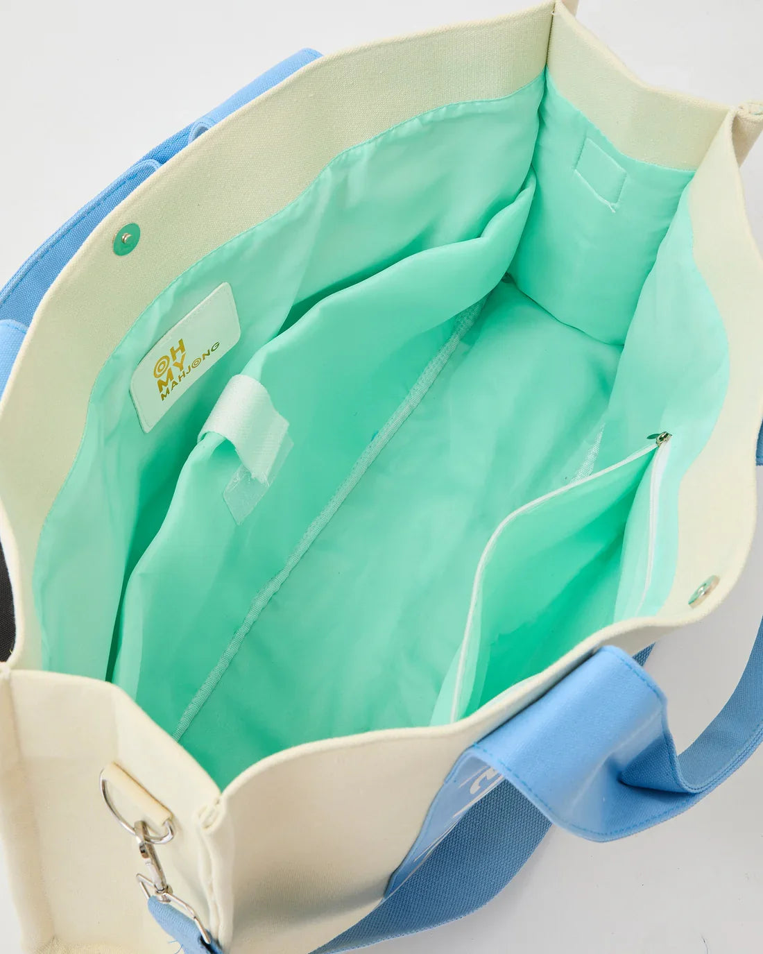 Light Blue Mahj It All bag interior with mint lining and zip pocket