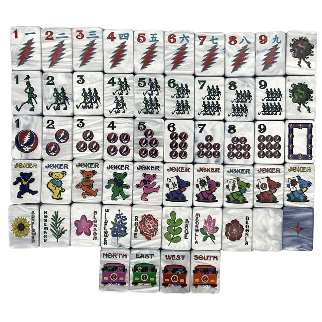 One of each Grateful Dead x Bespoke Mahjong Stealie Blue Tie Dye Pearl tile: lightning-bolt craks, dancing-skeleton bams, Steal Your Face dots, Dancing Bear jokers, named flowers, and tour-bus winds on light blue pearl