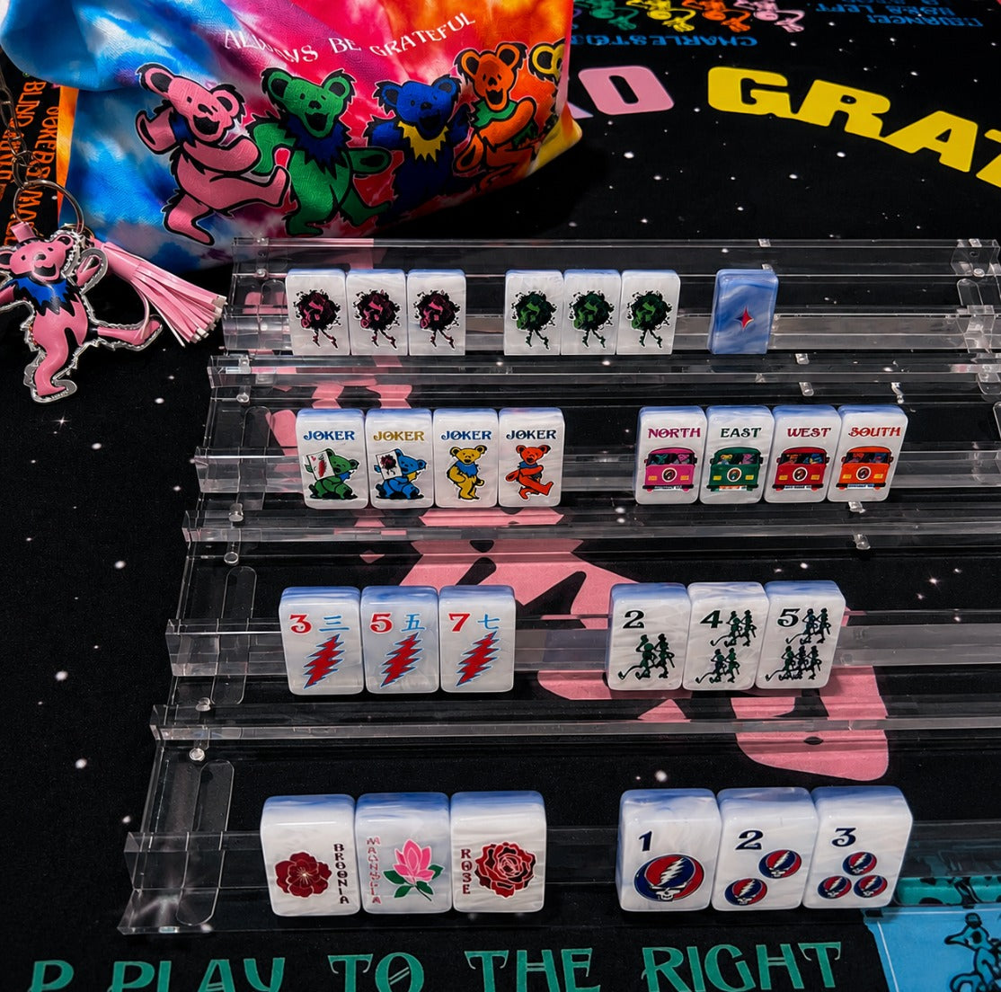 Stealie Blue tiles on clear racks showing Bertha dragons, Dancing Bear jokers, tour-bus winds, bolt craks, and flower tiles; racks and mat sold separately