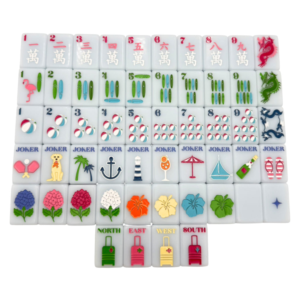 One of each Bespoke Mahjong x Gray Malin Beach Club Ocean Blue tile: red craks, longboard bams, beach-ball dots, beach jokers, hibiscus and hydrangea flowers, and suitcase winds on white