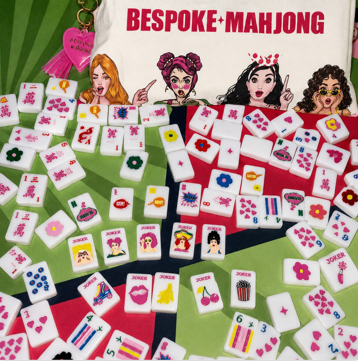Pop Divas Bright White tiles scattered on a comic-book mat with the Bespoke Mahjong tile bag; mat sold separately
