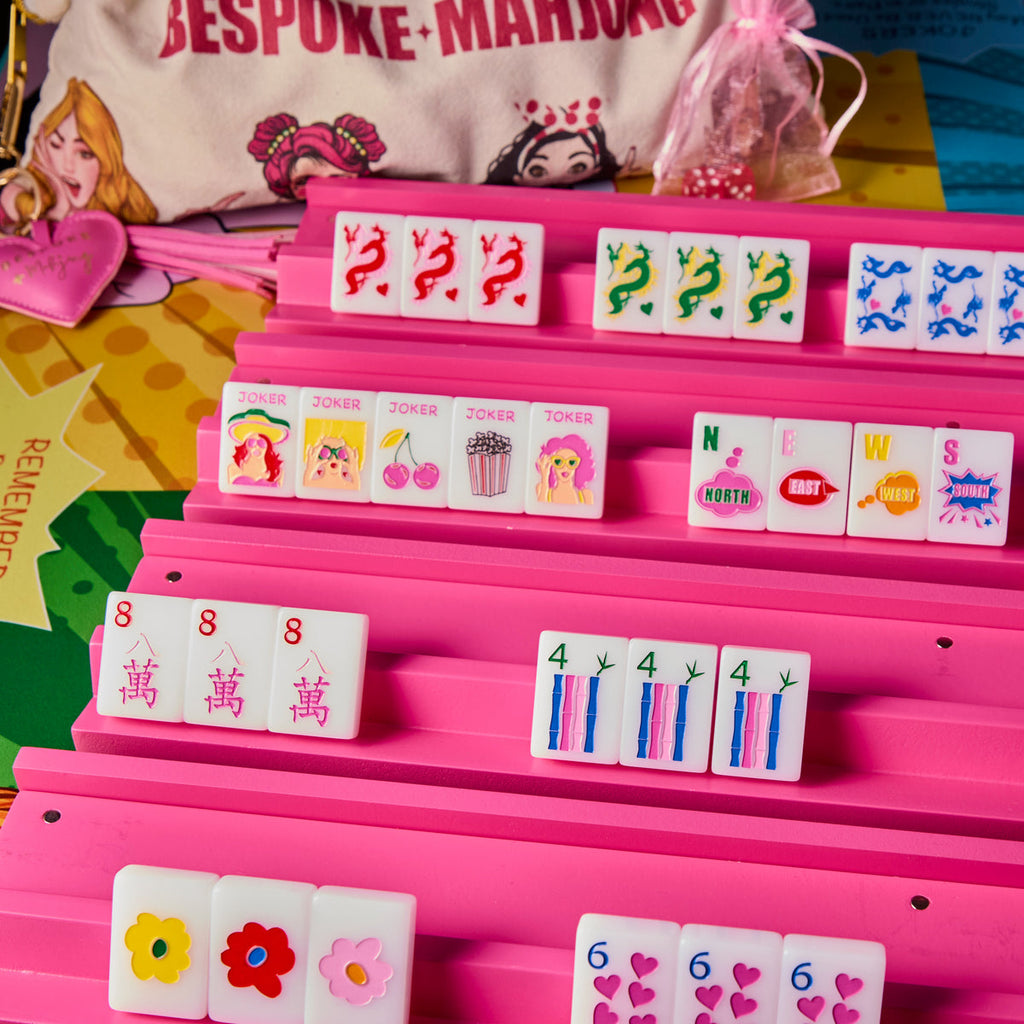Pop Divas Bright White tiles on pink racks with the pop-art Bespoke Mahjong tile bag; racks and mat sold separately