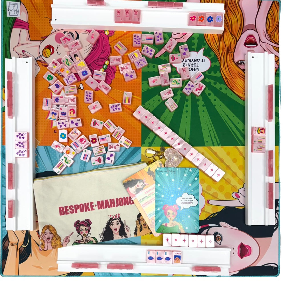 Overhead view of Pop Divas Bright White tiles on a pop-art mat with clear racks and the tile bag; racks and mat sold separately