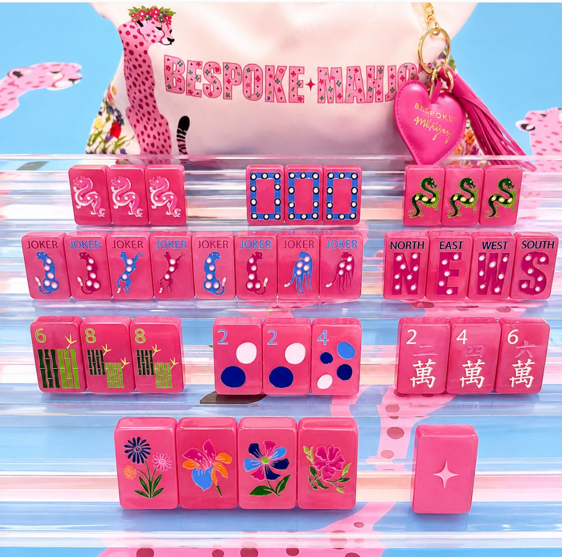 Springtime Safari Wild Pink Pearl tiles on clear racks with the cheetah-print Bespoke Mahjong tile bag; racks and mat sold separately
