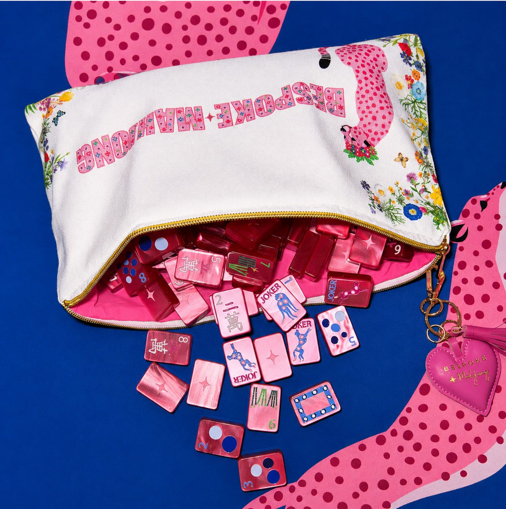 Springtime Safari Wild Pink Pearl tiles spilling from the Bespoke Mahjong tile bag on a cheetah mat; mat sold separately
