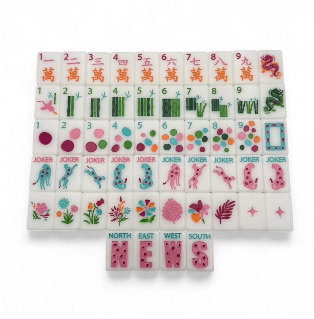 One of each Bespoke Mahjong Springtime Safari Bright White tile: pink craks, bamboo bams, multicolor dots, cheetah jokers, tropical flowers, and NEWS winds on white