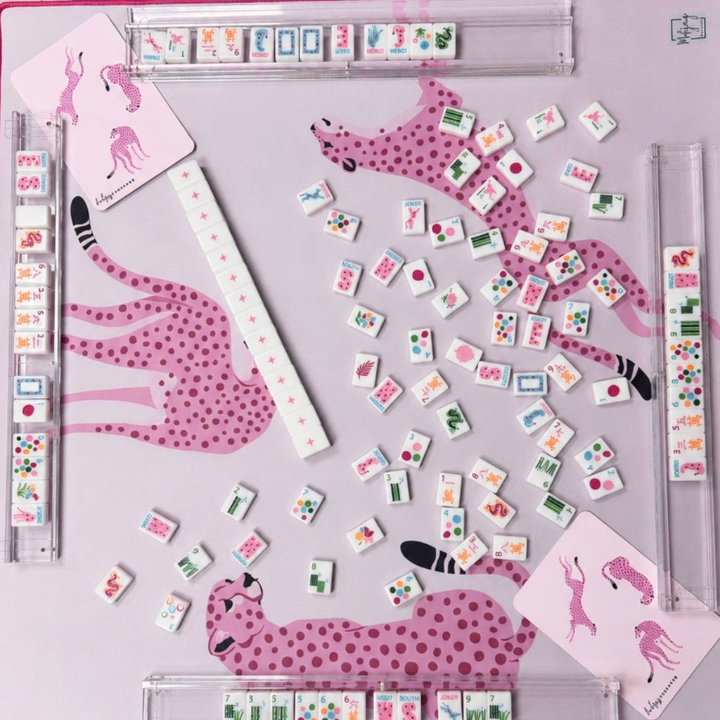 Overhead view of Springtime Safari Bright White tiles on a pink cheetah mat with clear racks; racks and mat sold separately