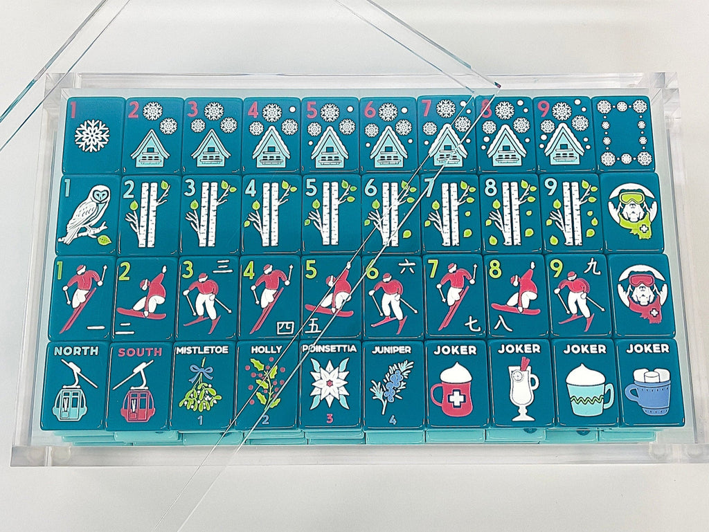 Après Ski Club tiles arranged in a clear acrylic display box with the lid propped open; display box sold separately