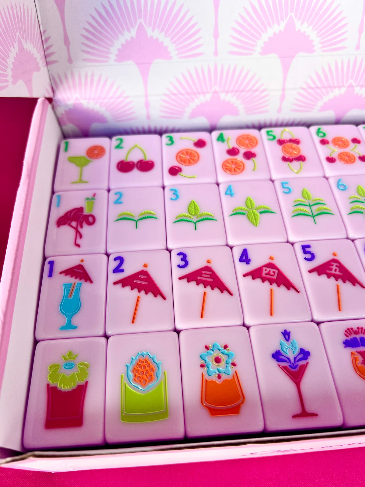 Cocktail Club 2.0 tiles packed in rows inside the pink Charleston Mahjong Club product box