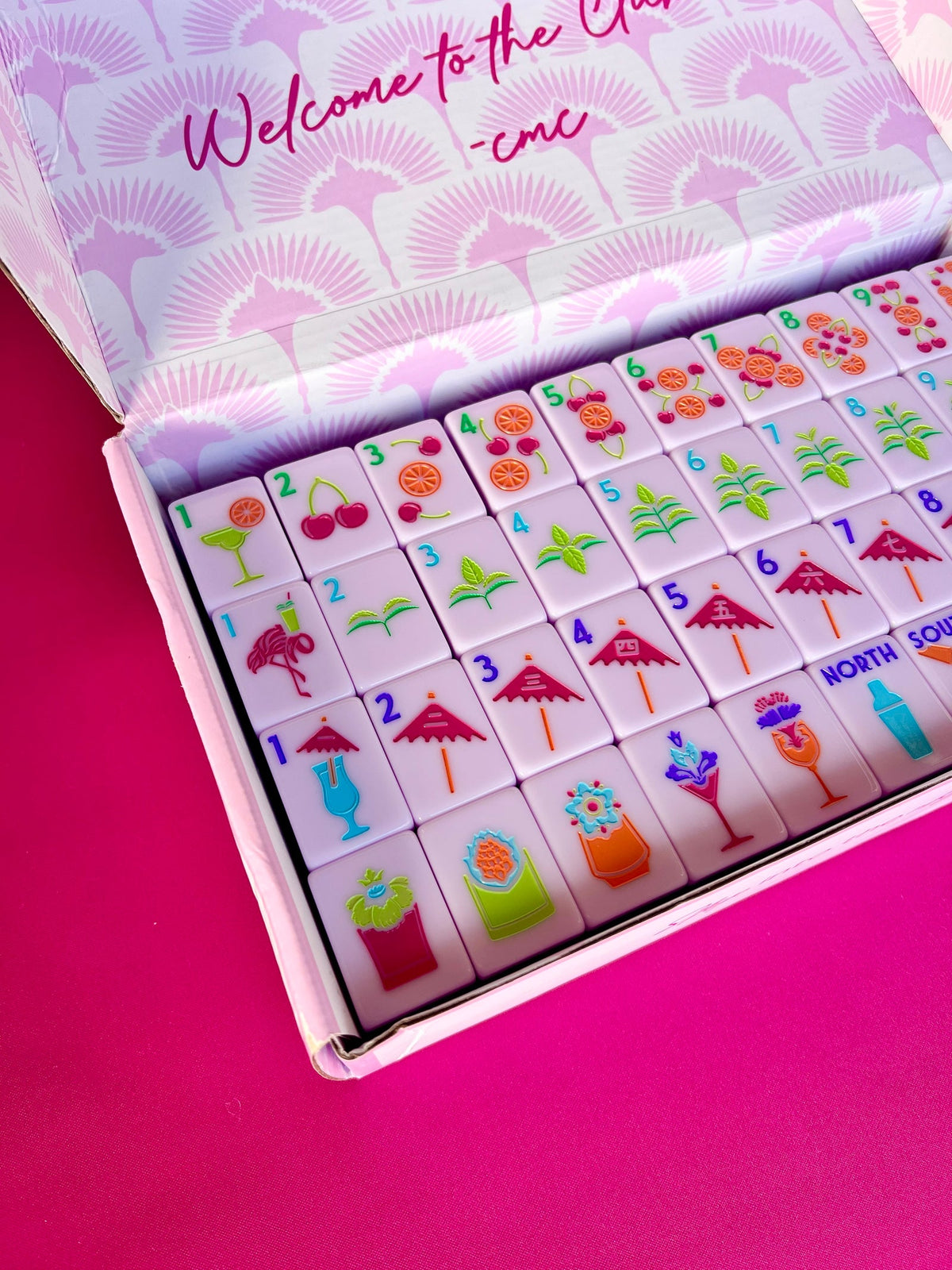 Cocktail Club 2.0 tiles in the open product box with the Welcome to the Club lid lining