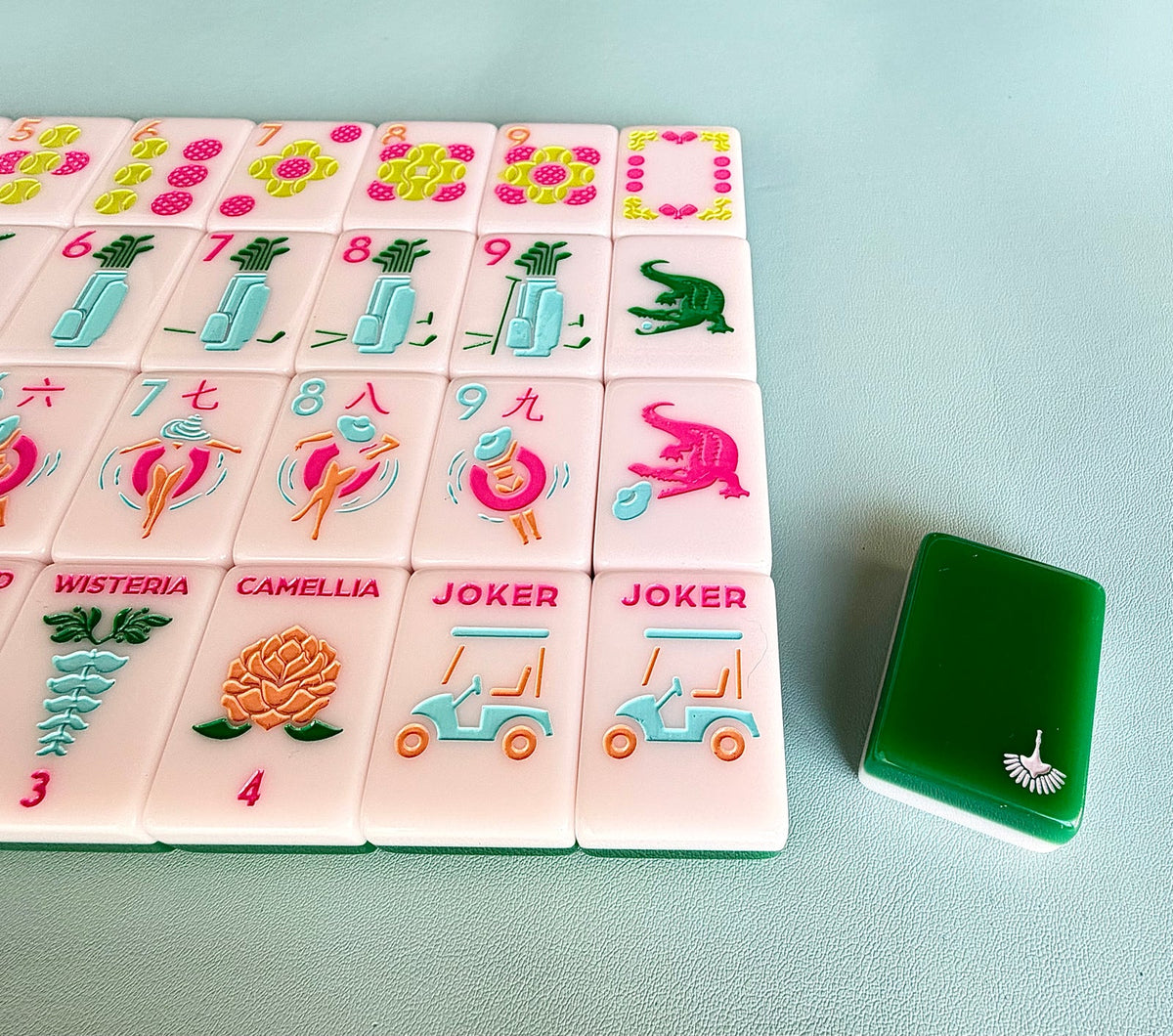 Close-up of Country Club joker tiles with a golf cart, the pink gator dragon, and the Camellia flower tile