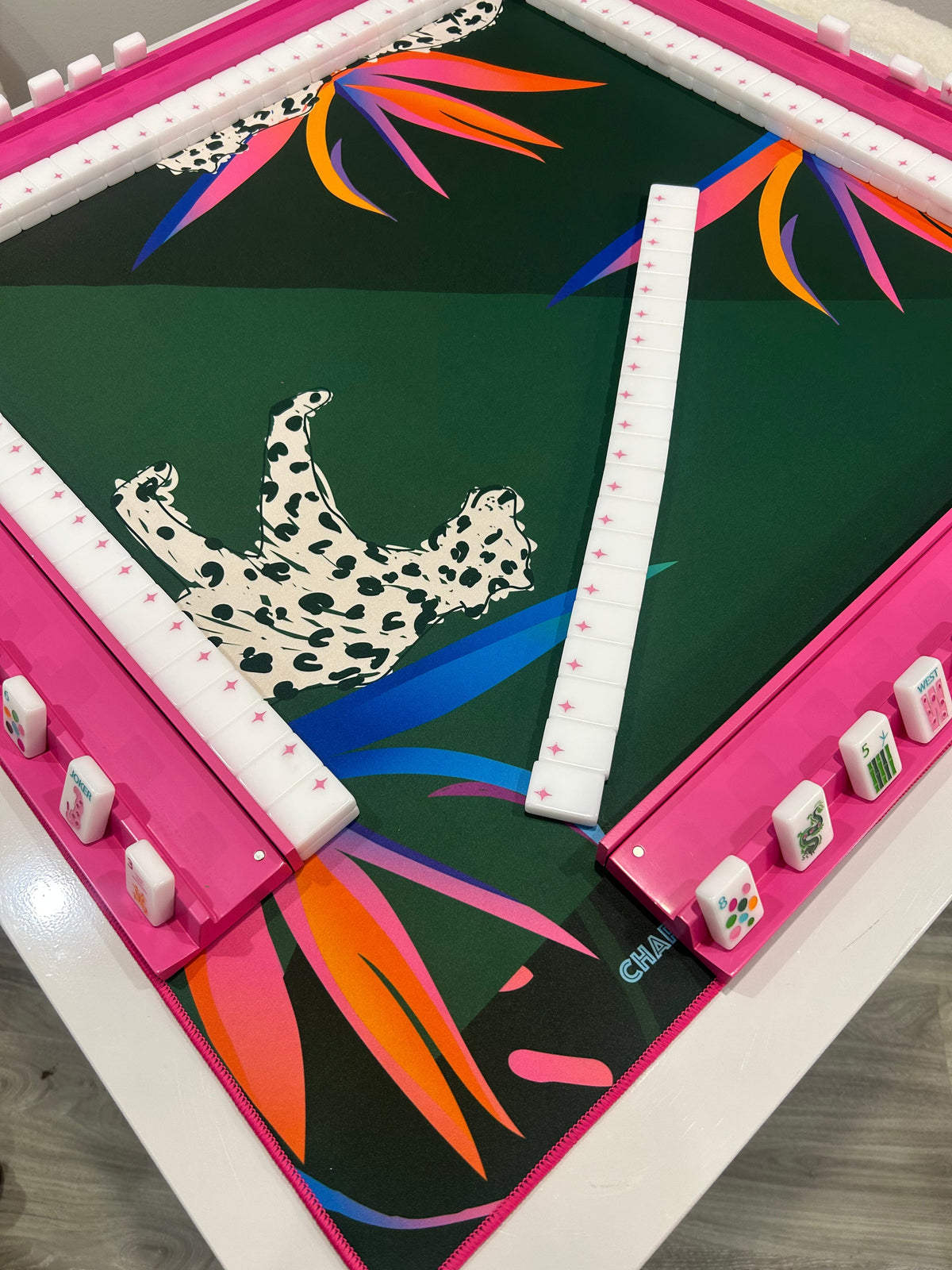 Cheetah Couture mahjong mat set up on a game table with racks; tiles and racks sold separately