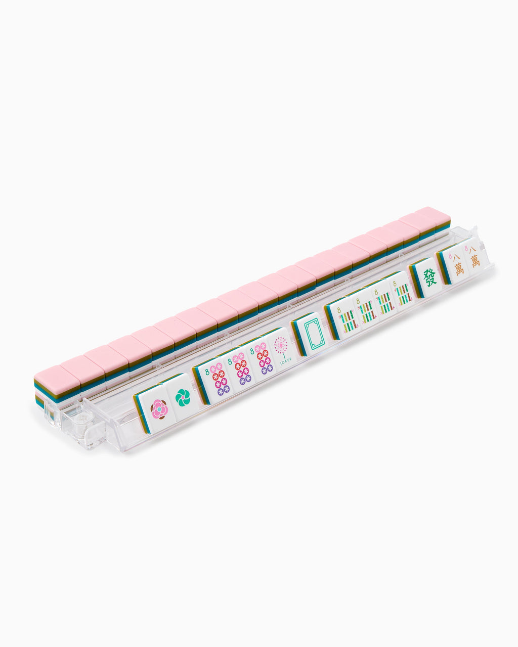 La Fete mahjong tiles on a clear acrylic rack, a row of face-up tiles in front and blush pink tile backs lined up behind