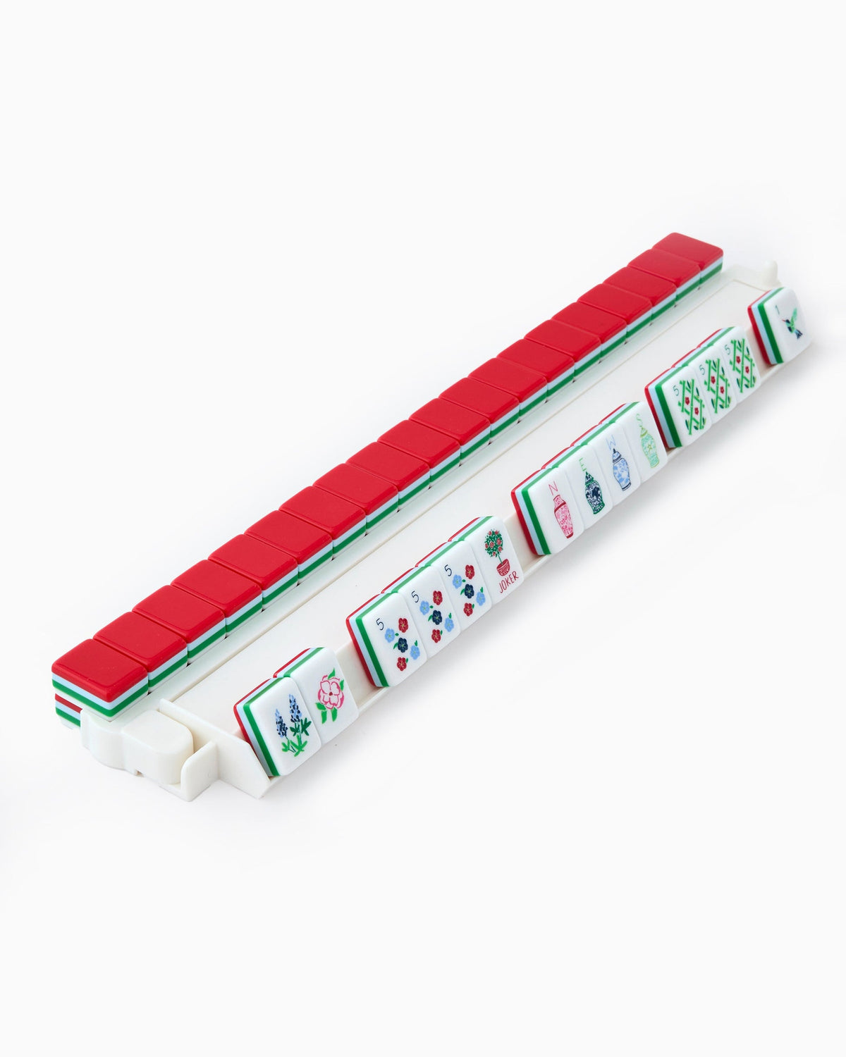 Nantucket mahjong tiles on a clear acrylic rack, a row of face-up tiles in front and red tile backs lined up behind