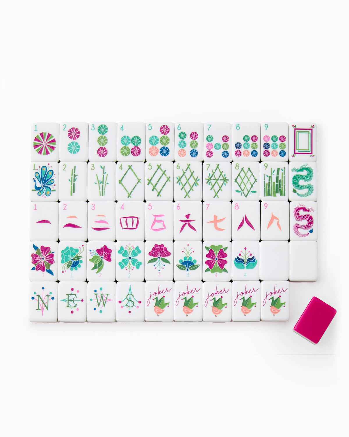One of each Oh My Mahjong Dandy tile face laid out in rows: dots, bams, craks, flowers, winds, and jokers, with a magenta tile back