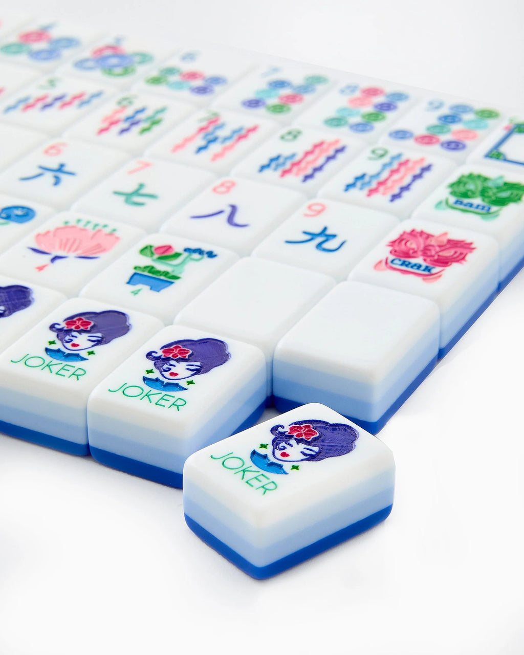 Close-up of Lola mahjong tiles, including two Joker tiles with the illustrated Lola character
