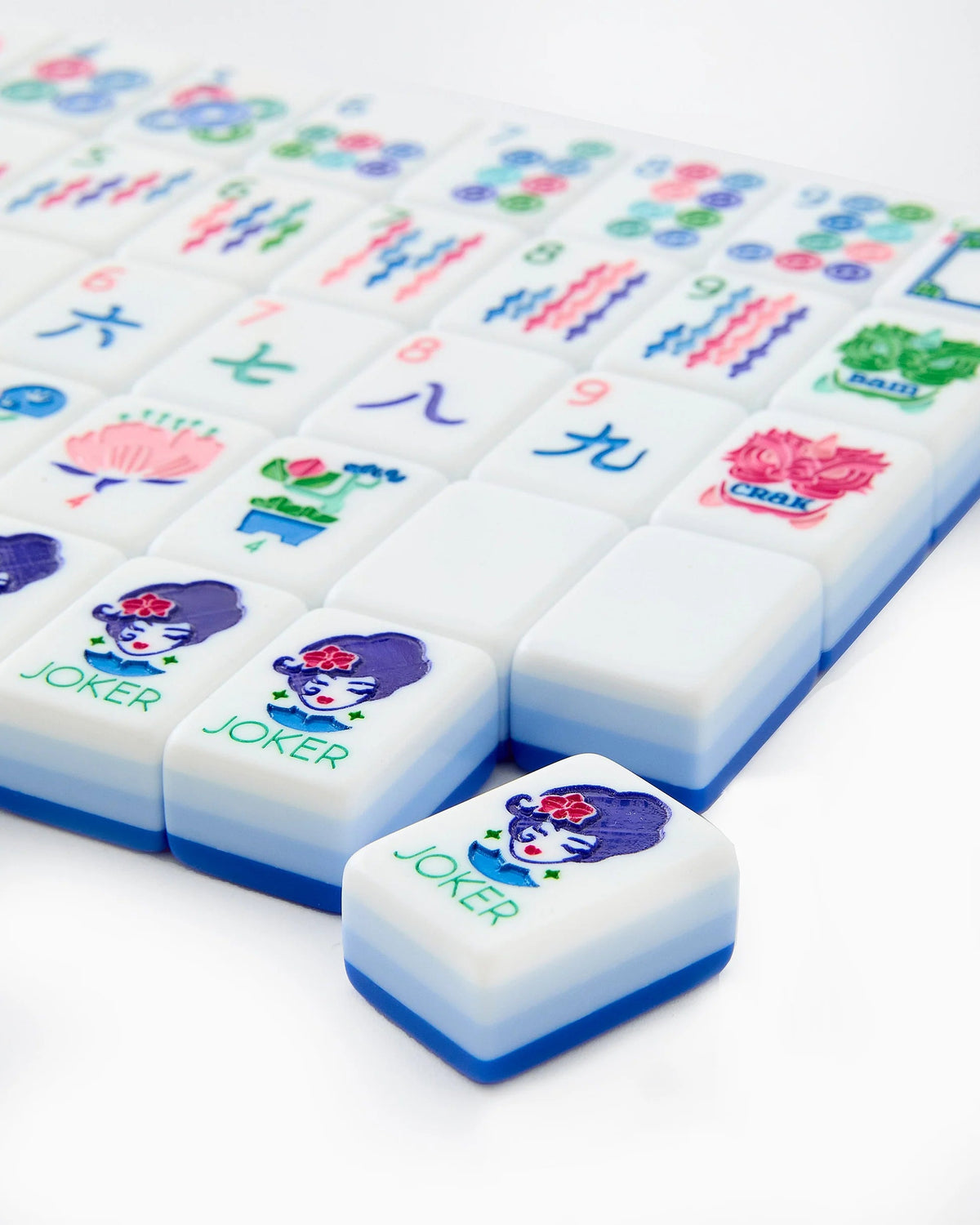 Close-up of Lola mahjong tiles, including two Joker tiles with the illustrated Lola character