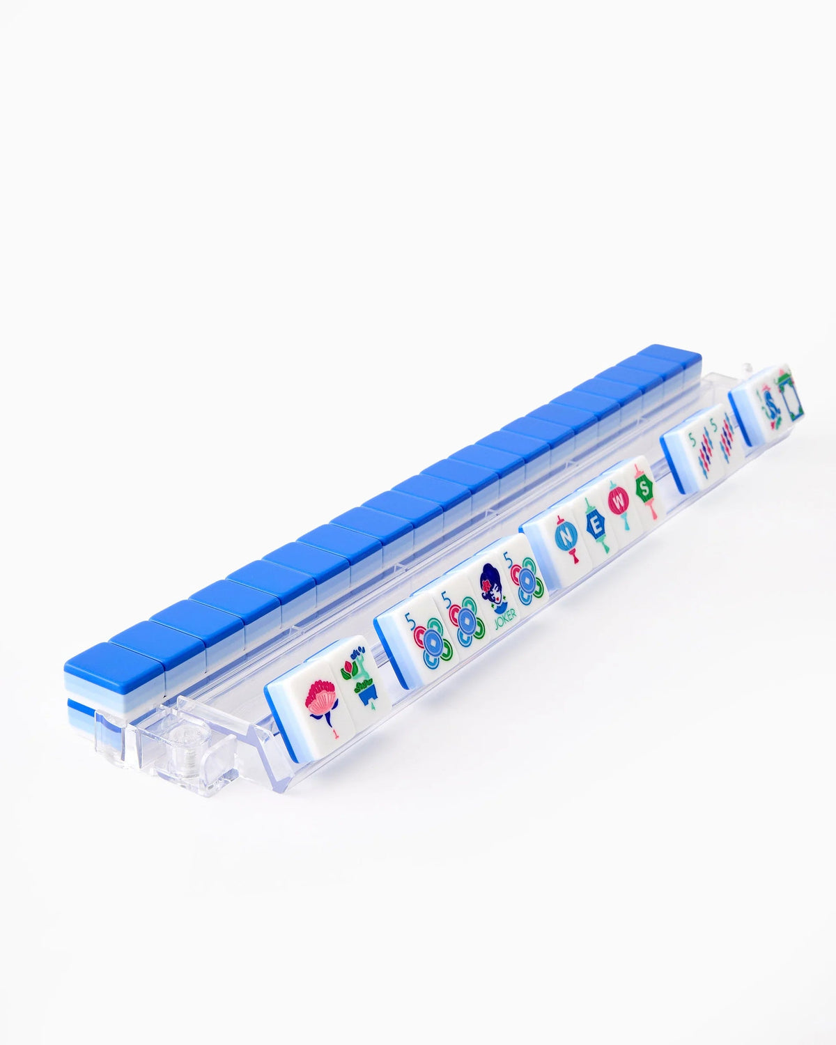 A hand of Lola mahjong tiles set up on a clear acrylic rack, with blue tile backs lined up behind