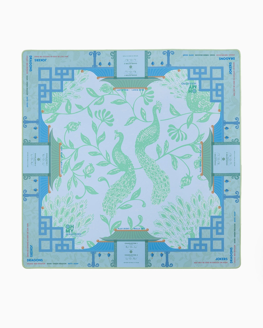 Oh My Mahjong Isla instructional mahjong mat laid flat, peacocks in soft green on cool blue