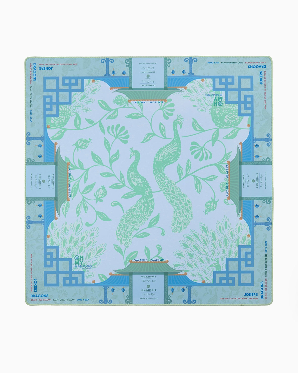 Oh My Mahjong Isla instructional mahjong mat laid flat, peacocks in soft green on cool blue