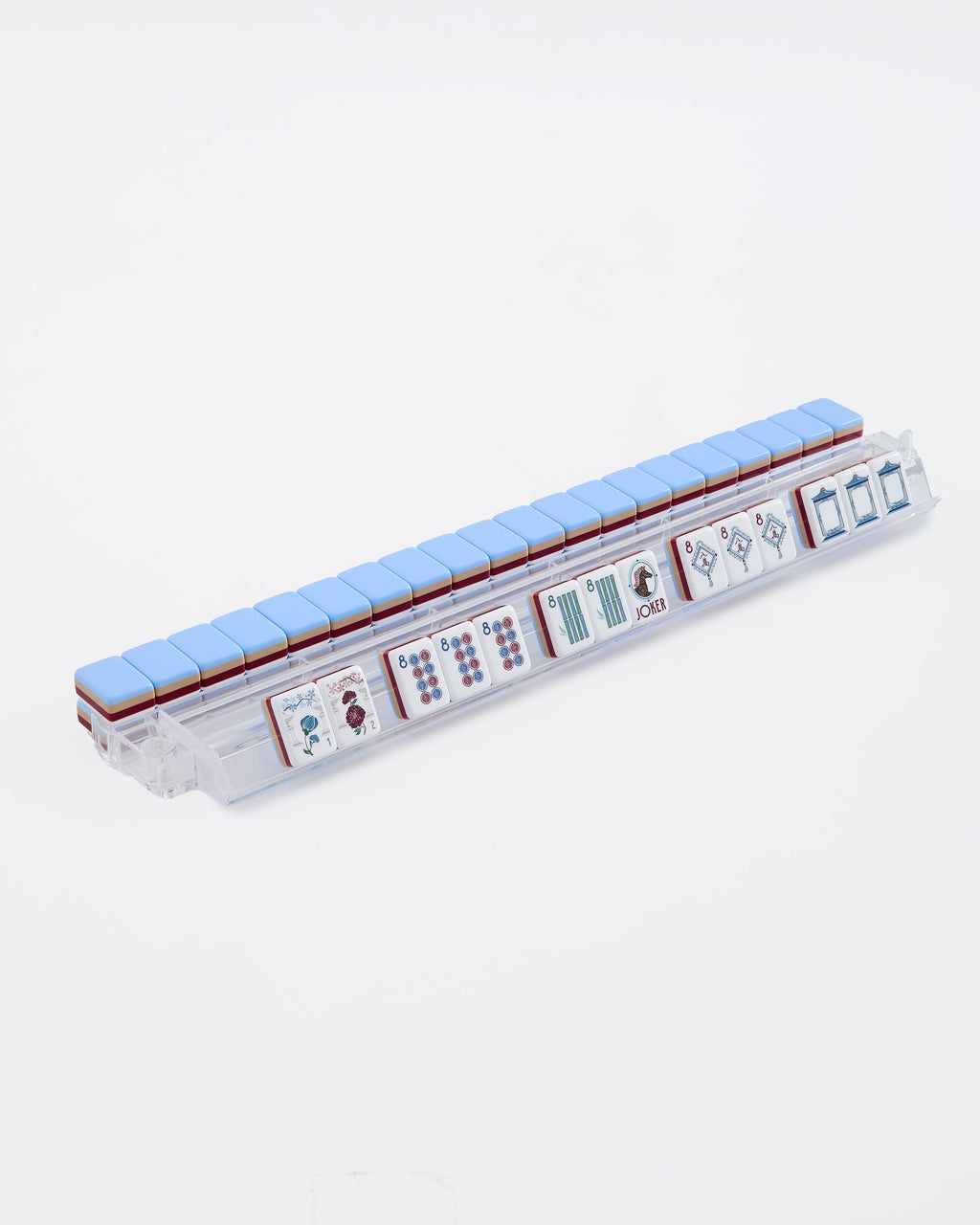 Osler mahjong tiles on a clear acrylic rack, a row of face-up tiles in front and pale blue tile backs lined up behind