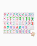 One of each Oh My Mahjong Pearlescent tile face laid out in rows: dots, bams, craks, flowers, winds, and jokers, with a pearly tile back