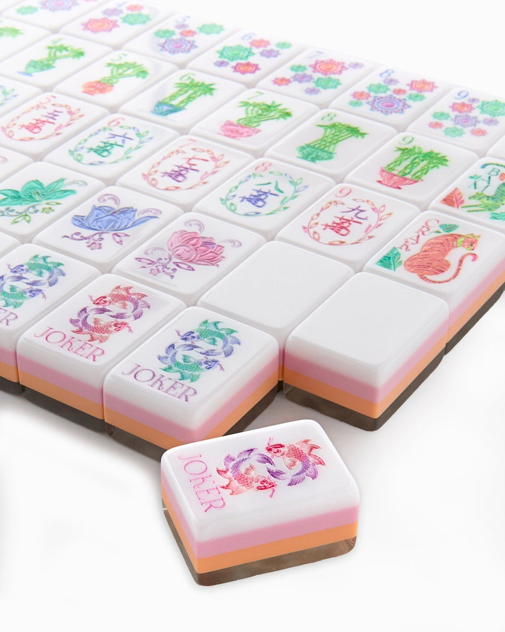 Close-up of Pearlescent joker tiles with a pair of koi, showing the layered pearl, blush, and peach tile edges