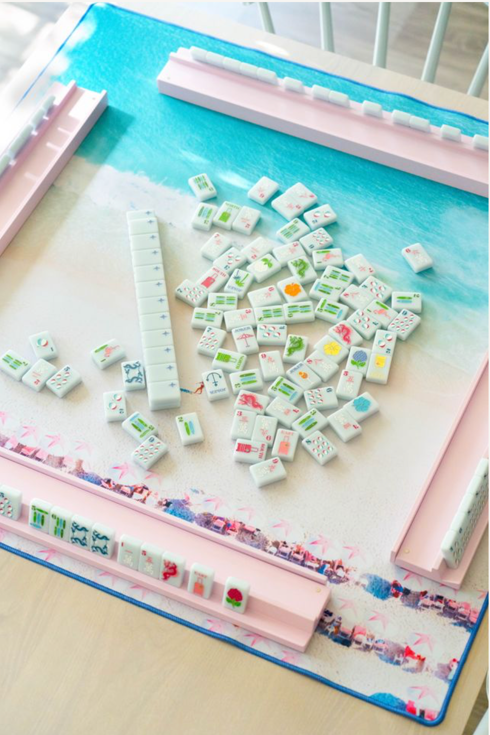 Gray Malin Beach Club mat set up for a game with tiles and pink racks; tiles and racks sold separately