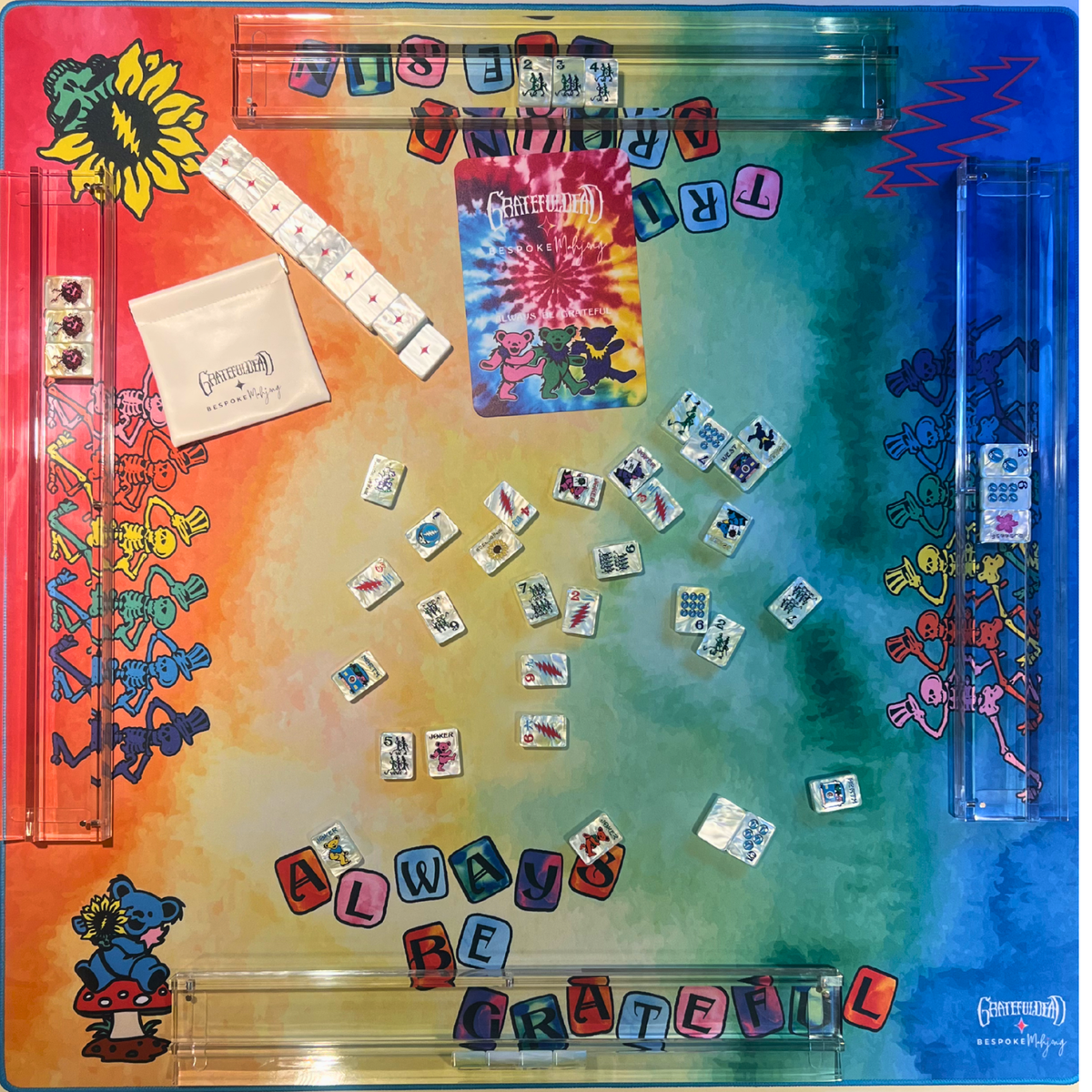 Rainbow tie dye side of the Grateful Dead mahjong mat with racks and tiles; tiles and racks sold separately