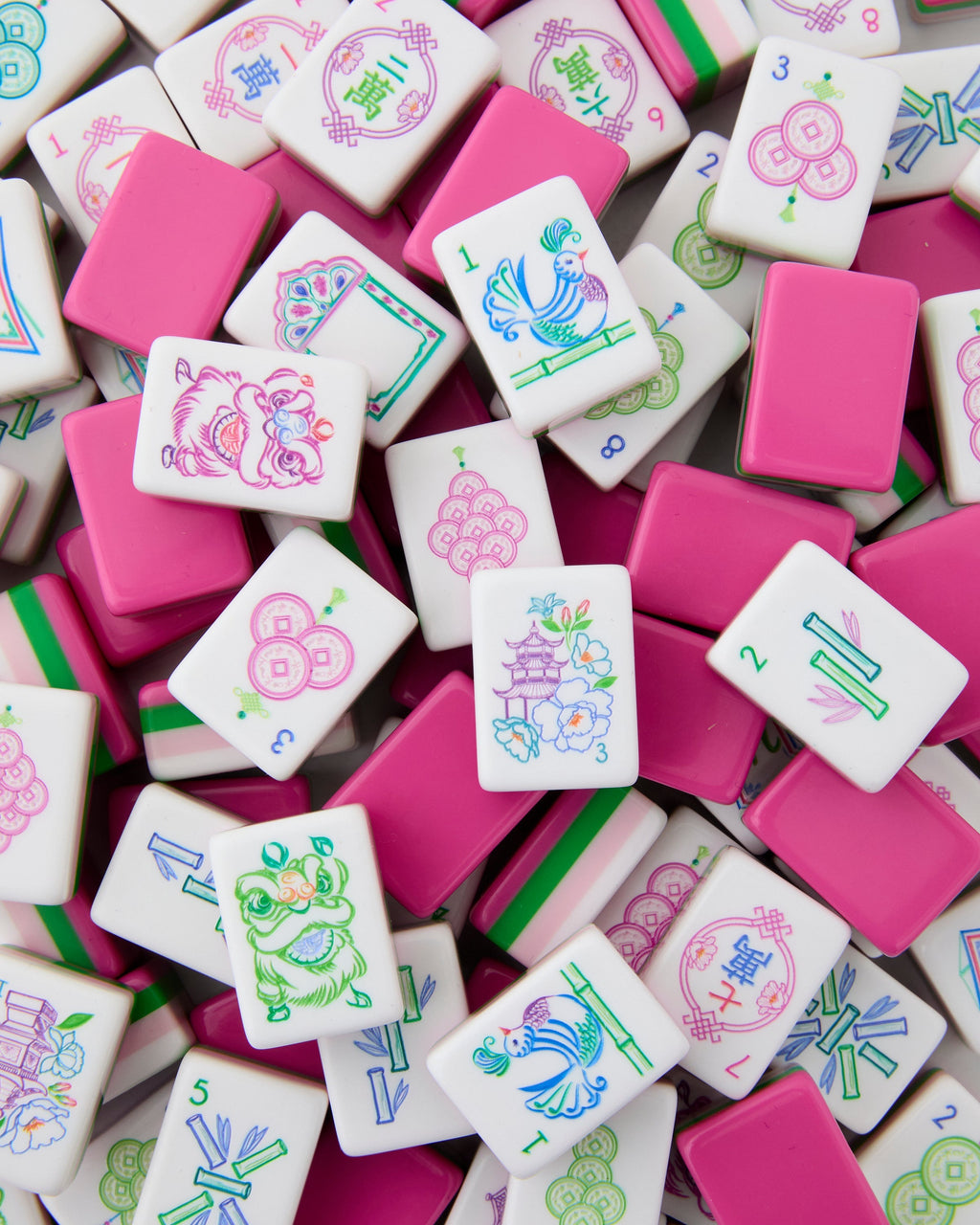 Amara tiles scattered face up and face down showing pink tile backs