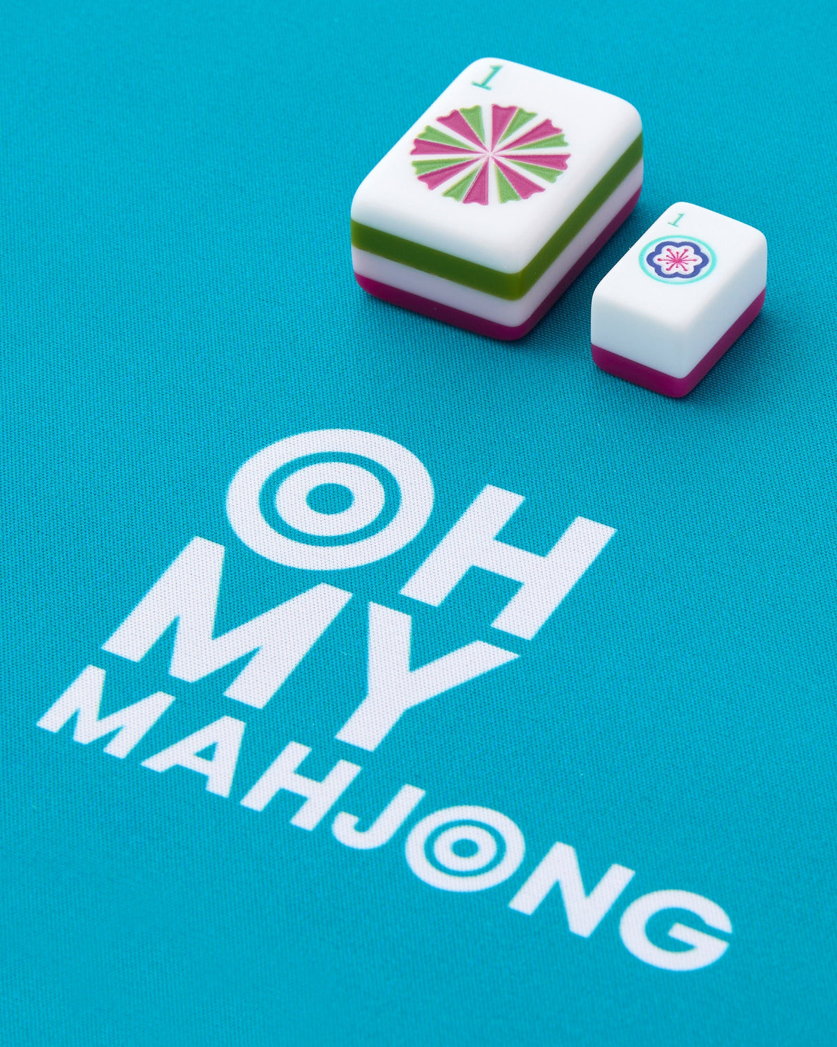 Charleston tiles on the teal Oh My Mahjong travel mat