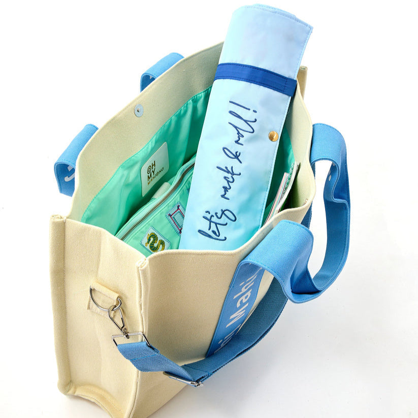 Light Blue Mahj It All bag open with a rolled rack bag inside; accessories sold separately