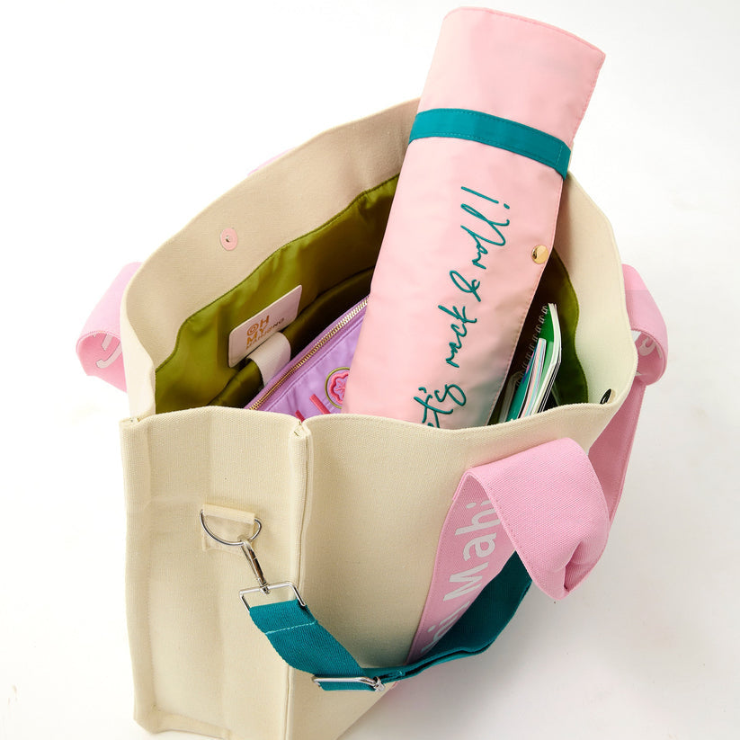 Light Pink Mahj It All bag open with a rolled rack bag inside; accessories sold separately