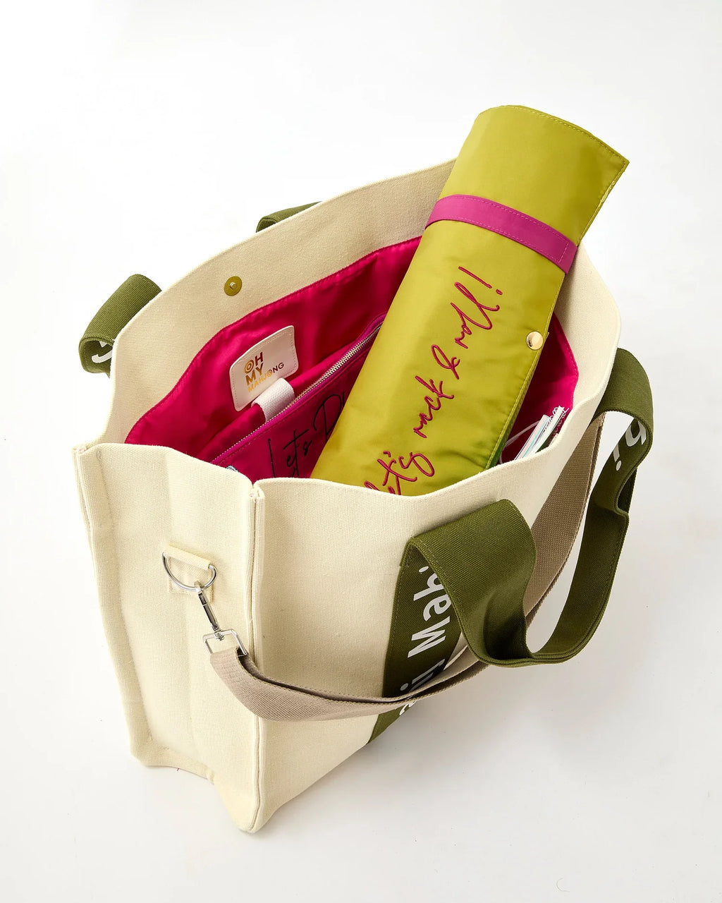 Olive Mahj It All bag open with a rolled rack bag inside; accessories sold separately