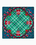 Oh My Mahjong Yuletide holiday mahjong mat laid flat, evergreen and red with a plaid center, lanterns, and bows